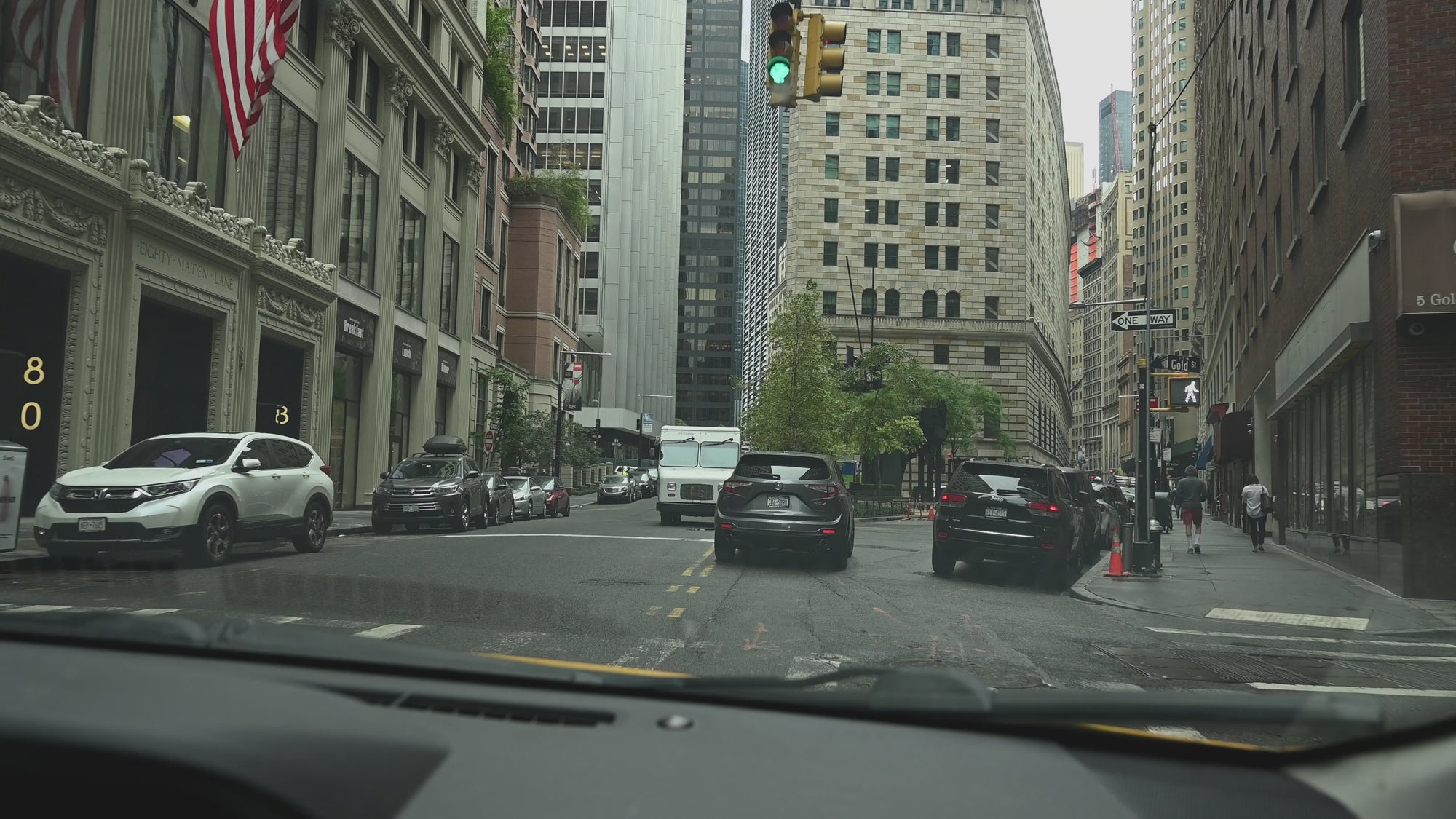 Driving down a busy Street in New York, recording from a moving vehicle, behind the windscreen .